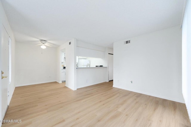 spare room with ceiling fan and light hardwood / wood-style floors