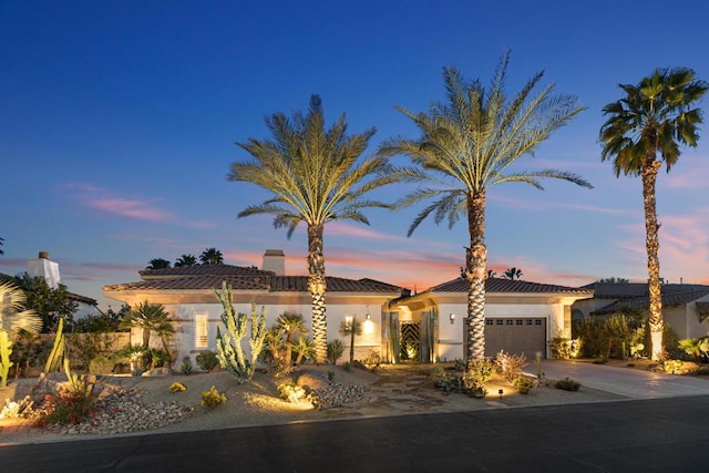 mediterranean / spanish house with a garage