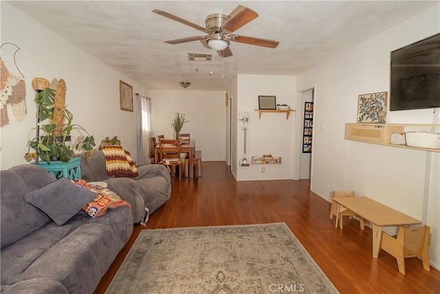 living room with hardwood / wood-style flooring and ceiling fan