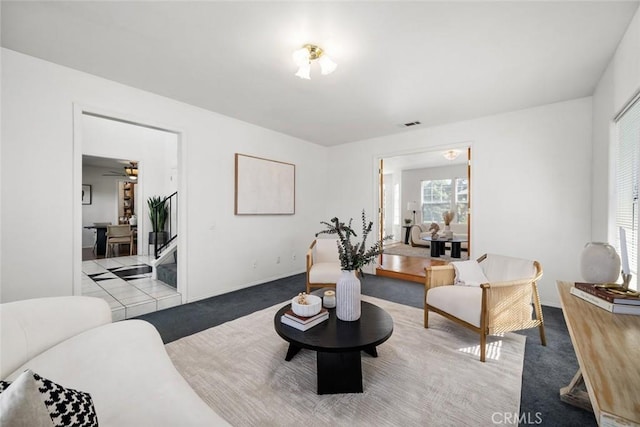 living room with light carpet and ceiling fan