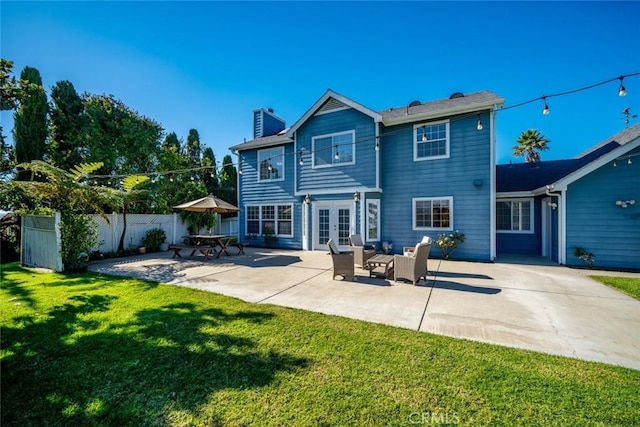 rear view of house featuring a patio area, outdoor lounge area, a yard, and french doors