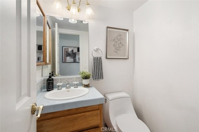 bathroom featuring vanity and toilet