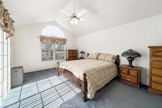 bedroom with dark colored carpet, ceiling fan, and vaulted ceiling