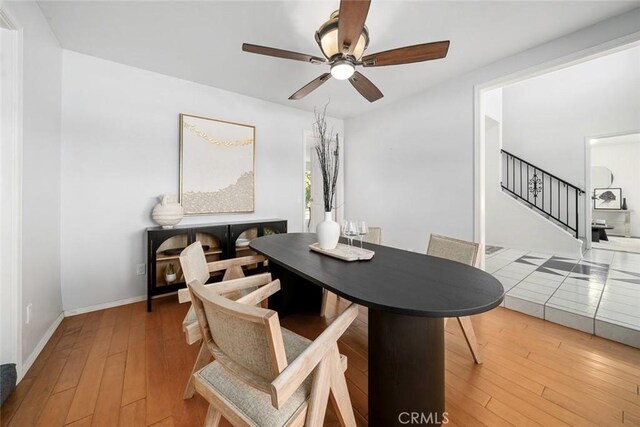 dining area with hardwood / wood-style floors and ceiling fan