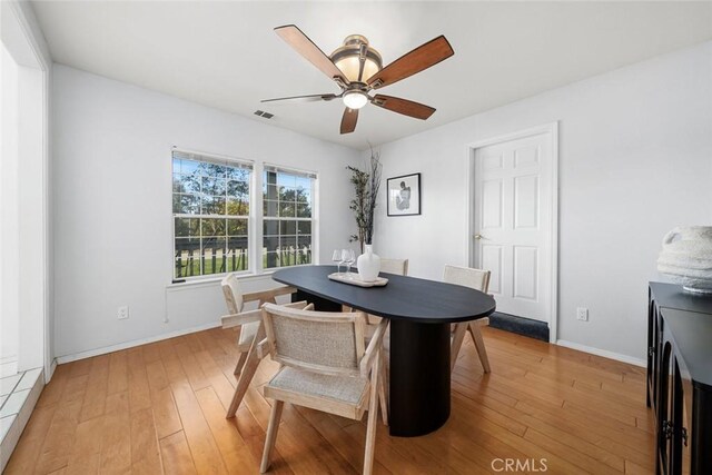 dining room with ceiling fan and light hardwood / wood-style floors