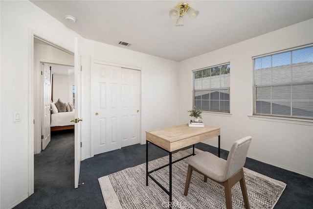 office area featuring dark colored carpet