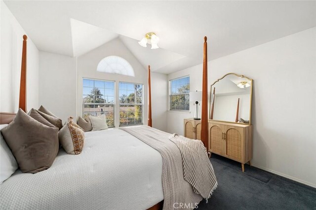 carpeted bedroom with lofted ceiling