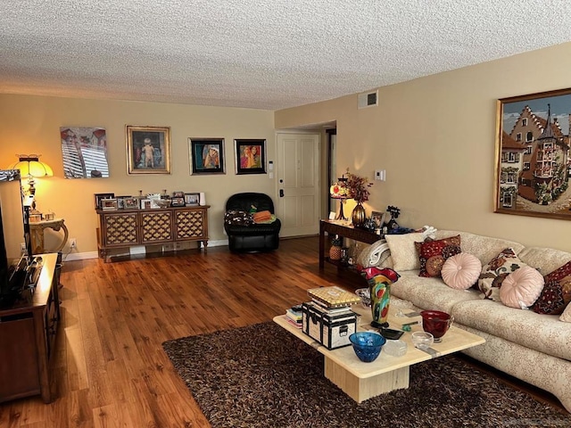 living room with hardwood / wood-style floors and a textured ceiling