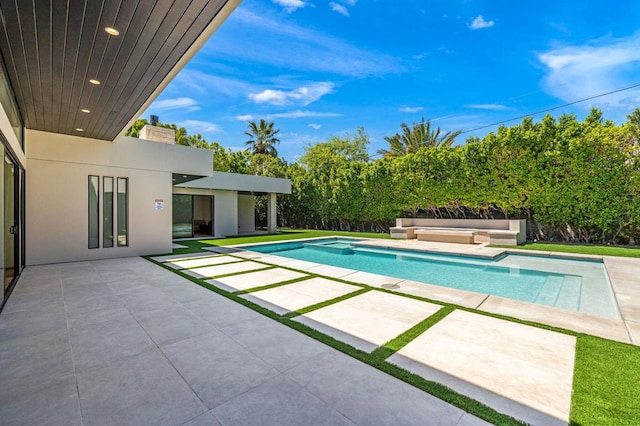 view of swimming pool with a patio and a hot tub