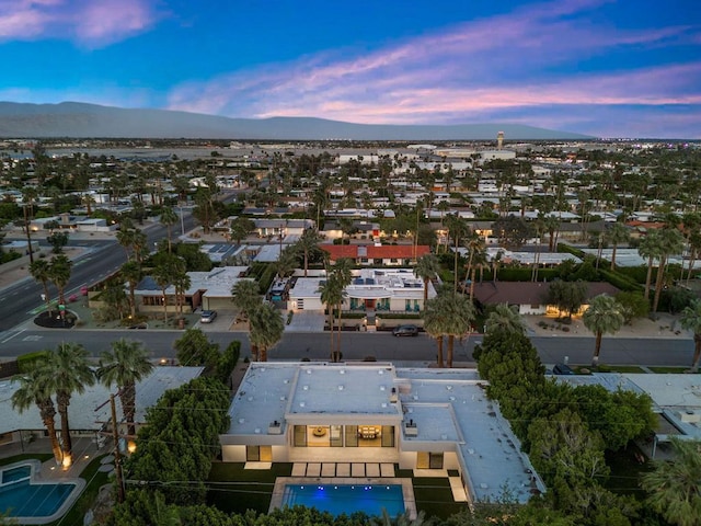 aerial view at dusk featuring a mountain view