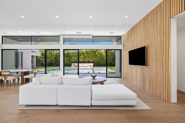 living room featuring light hardwood / wood-style floors and wood walls