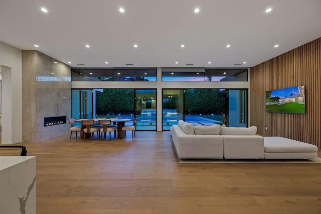 living room featuring light hardwood / wood-style floors and a tile fireplace