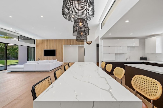 dining room featuring wooden walls and light hardwood / wood-style floors