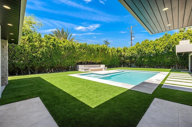 view of swimming pool with a lawn