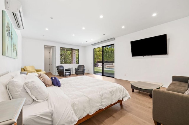 bedroom with access to exterior and light hardwood / wood-style floors