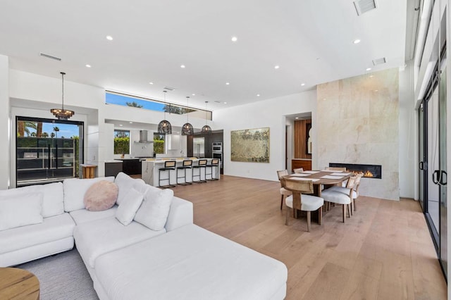 living room featuring light hardwood / wood-style floors and a tiled fireplace