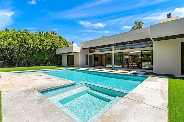 view of pool featuring a patio area and an in ground hot tub