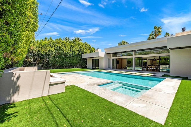 view of swimming pool with a patio area, a yard, and an in ground hot tub