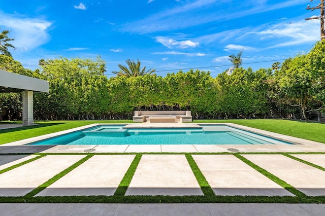 view of swimming pool with a lawn