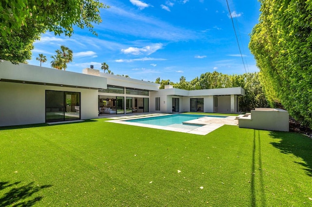 back of house with a lawn and a patio