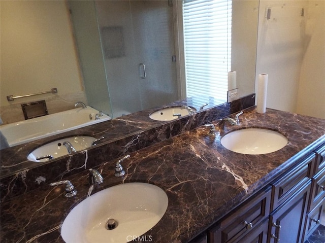 bathroom featuring vanity and a bath