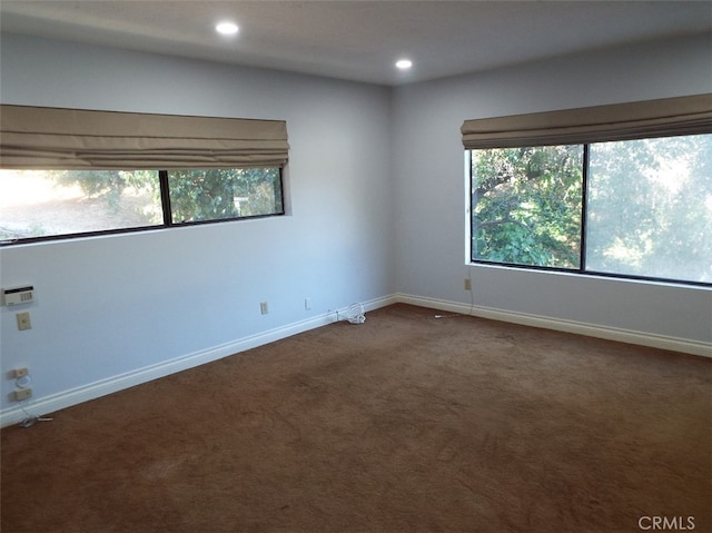 carpeted empty room with a wealth of natural light