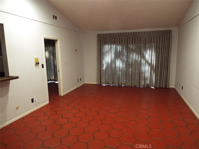 empty room featuring lofted ceiling