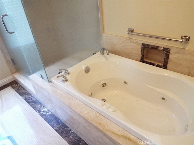 bathroom featuring tiled tub