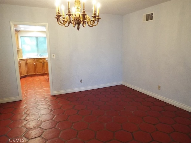 empty room featuring a chandelier