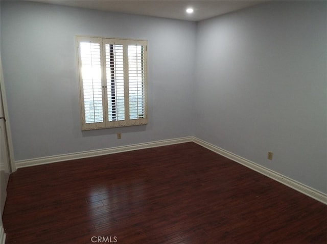 unfurnished room featuring dark hardwood / wood-style flooring