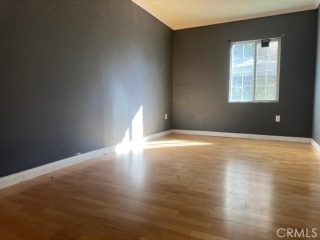 empty room with light hardwood / wood-style flooring