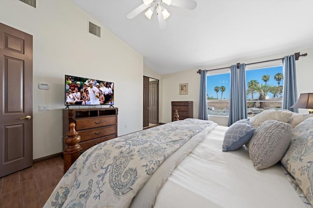 bedroom featuring a closet, hardwood / wood-style flooring, ceiling fan, and lofted ceiling