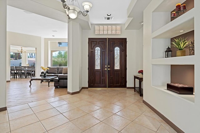 entryway featuring light tile patterned floors and an inviting chandelier