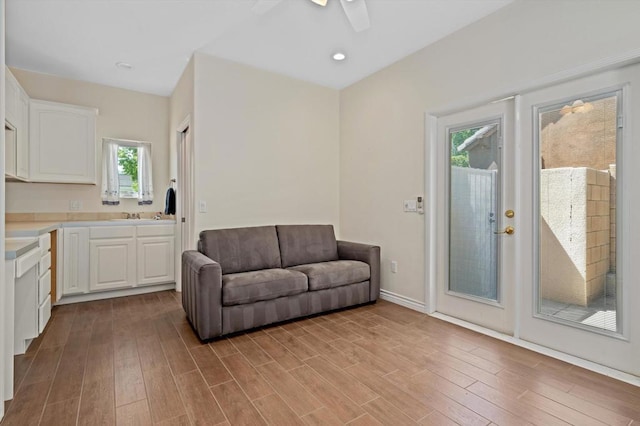 living room featuring ceiling fan, a healthy amount of sunlight, and light hardwood / wood-style flooring