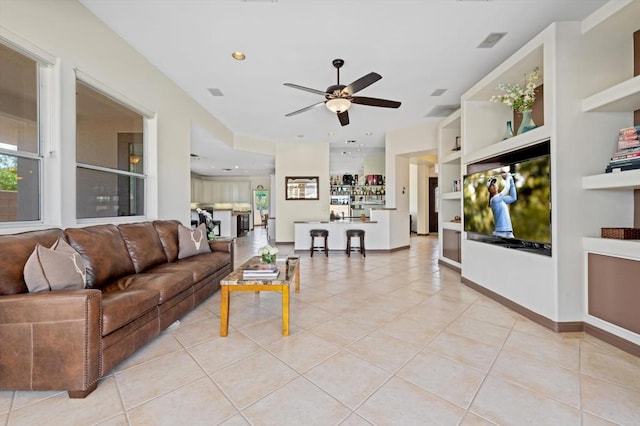 tiled living room featuring ceiling fan