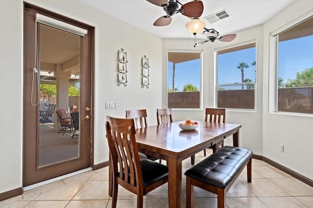 tiled dining area with ceiling fan and a healthy amount of sunlight