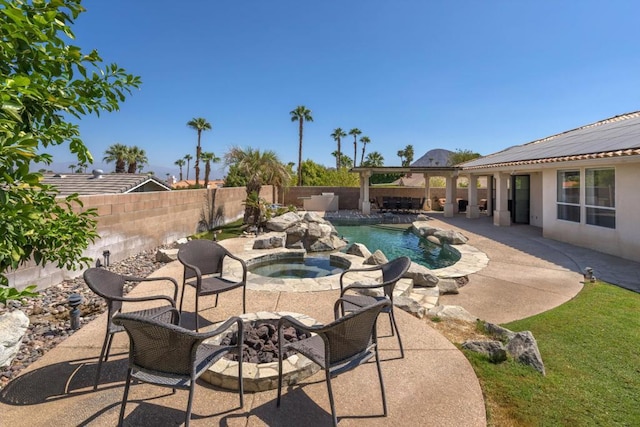 view of swimming pool featuring an in ground hot tub and a patio