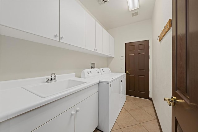 laundry room featuring washer and dryer, light tile patterned floors, cabinets, and sink