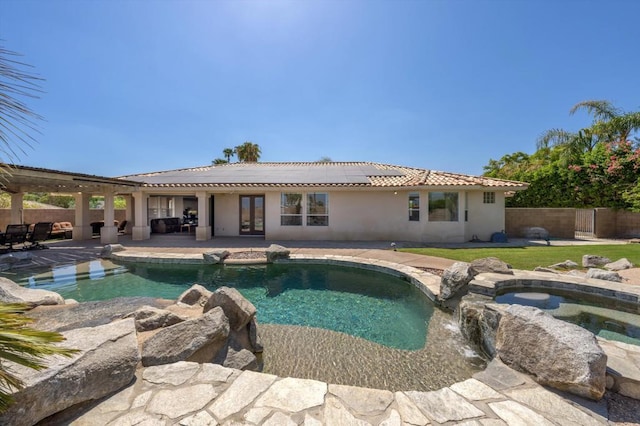 view of swimming pool featuring an in ground hot tub, french doors, and a patio area