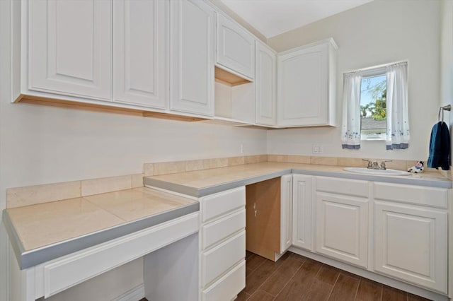 kitchen featuring dark hardwood / wood-style flooring, white cabinetry, and sink