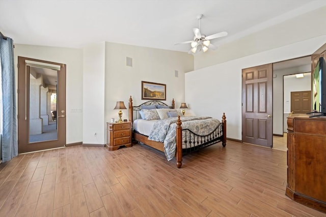 bedroom featuring light hardwood / wood-style floors, ceiling fan, and lofted ceiling