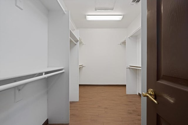 spacious closet featuring light hardwood / wood-style floors