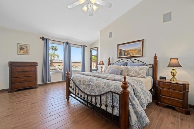 bedroom featuring hardwood / wood-style floors, access to outside, high vaulted ceiling, and ceiling fan