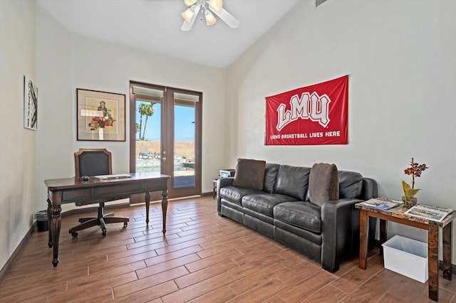 office space with ceiling fan, french doors, high vaulted ceiling, and hardwood / wood-style flooring