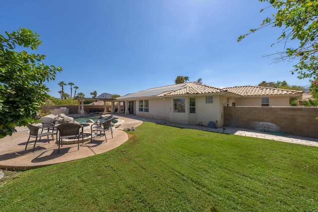 rear view of house with a yard and a patio