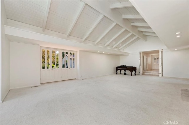 interior space with beam ceiling, high vaulted ceiling, and carpet flooring