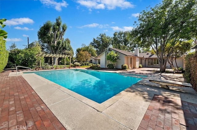 view of swimming pool with a pergola and a patio area