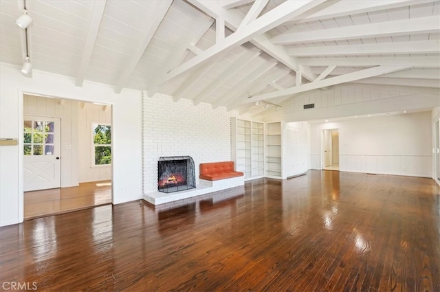 unfurnished living room with lofted ceiling with beams, a fireplace, and dark hardwood / wood-style flooring