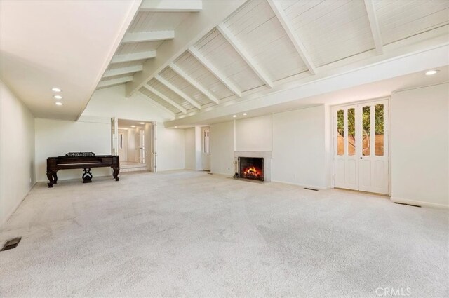 living room with beam ceiling, light colored carpet, and high vaulted ceiling