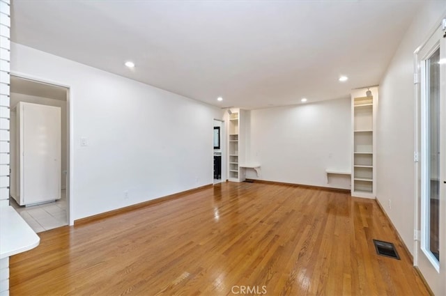 unfurnished living room featuring light hardwood / wood-style floors